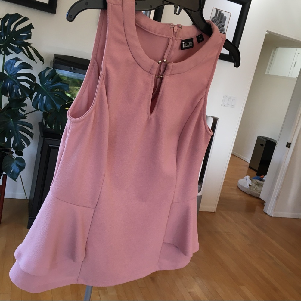 Pink blouse with side flares and neckline accent